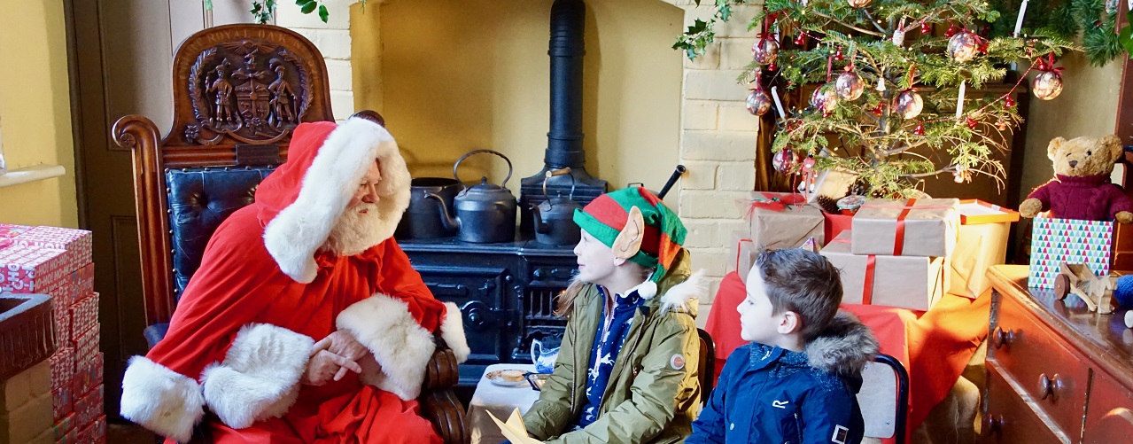 Santa with two boys in elf ears