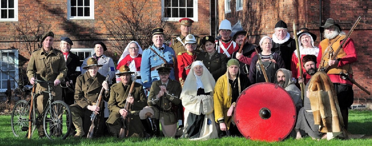 A press shot of living history reenactors in The Commandery gardens.