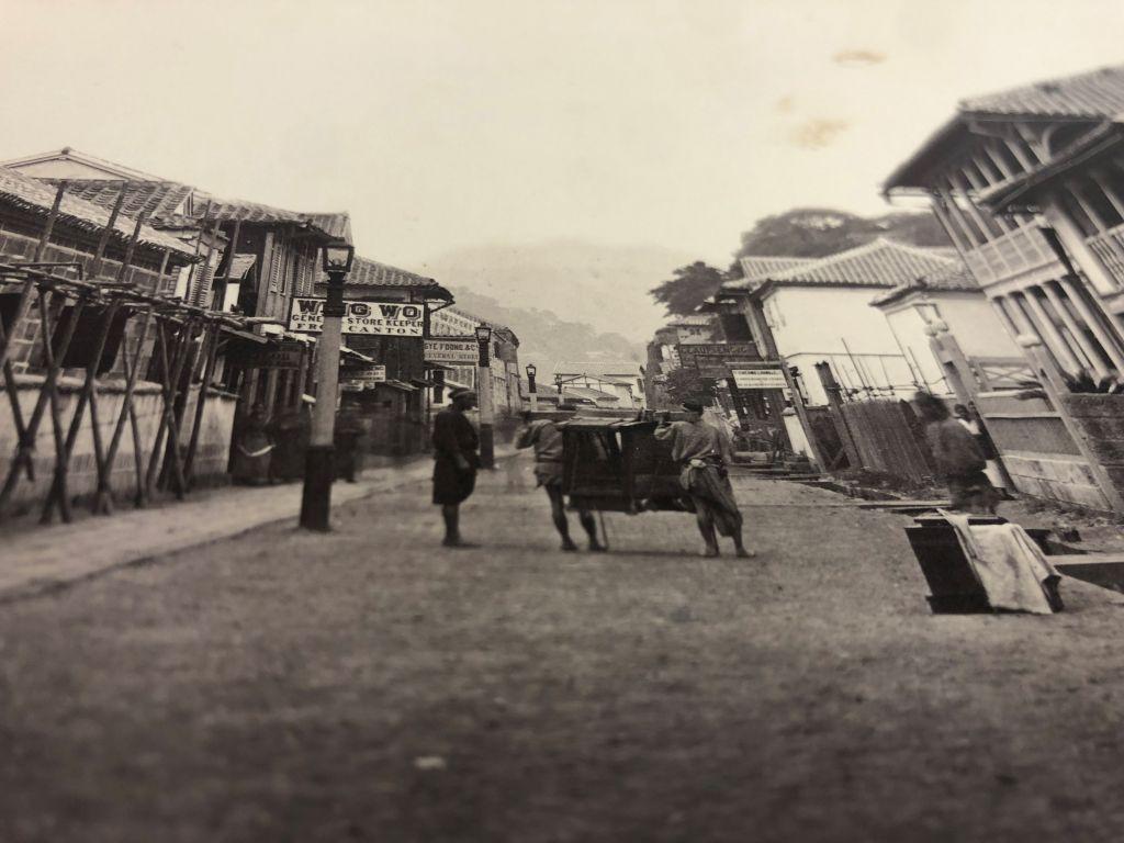 A street in Nagasaki, 1872. Traditional life carries on in a time of change.