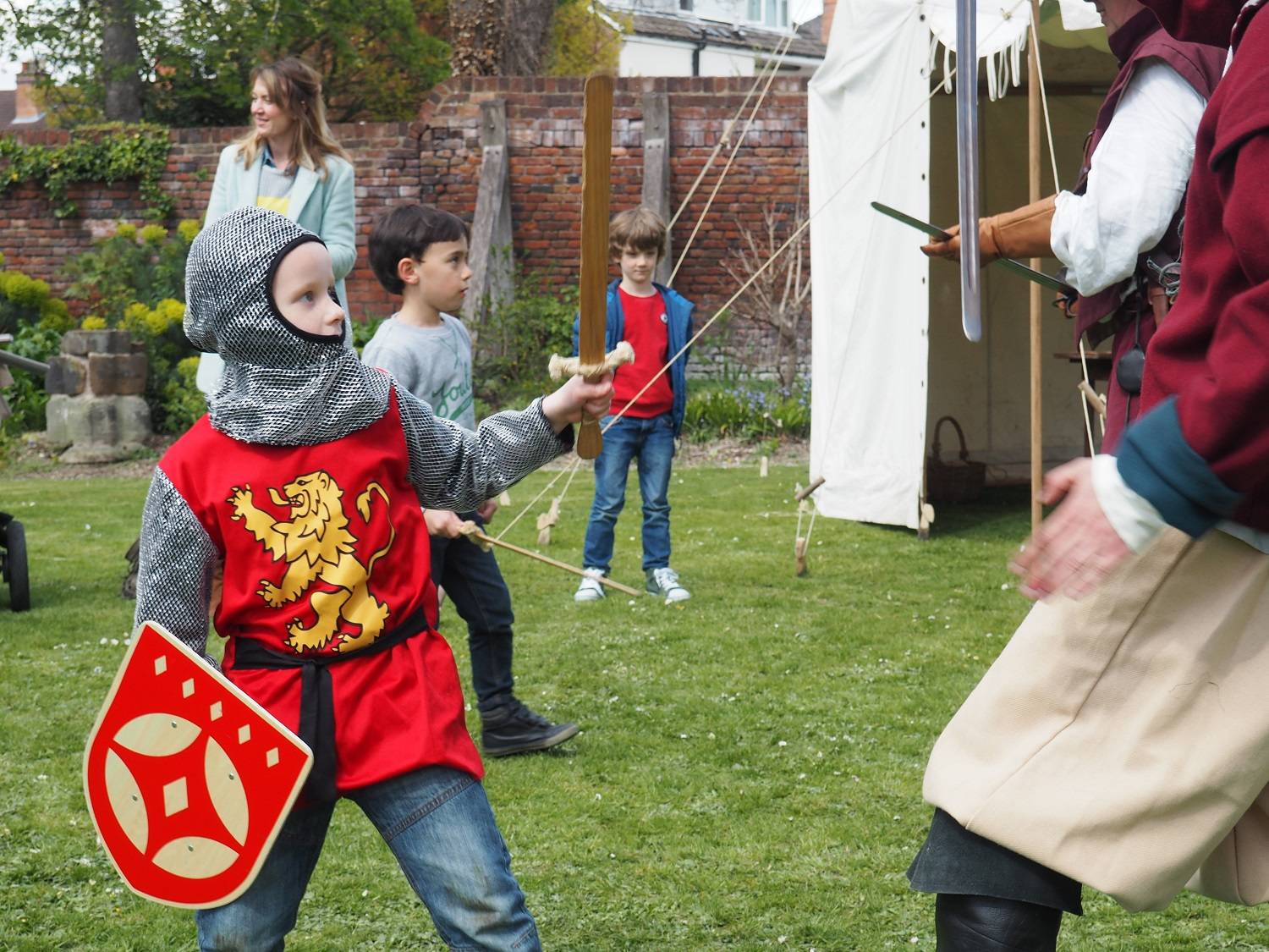 A photo showing a child dressed up as a soldier in The Commandery's garden.