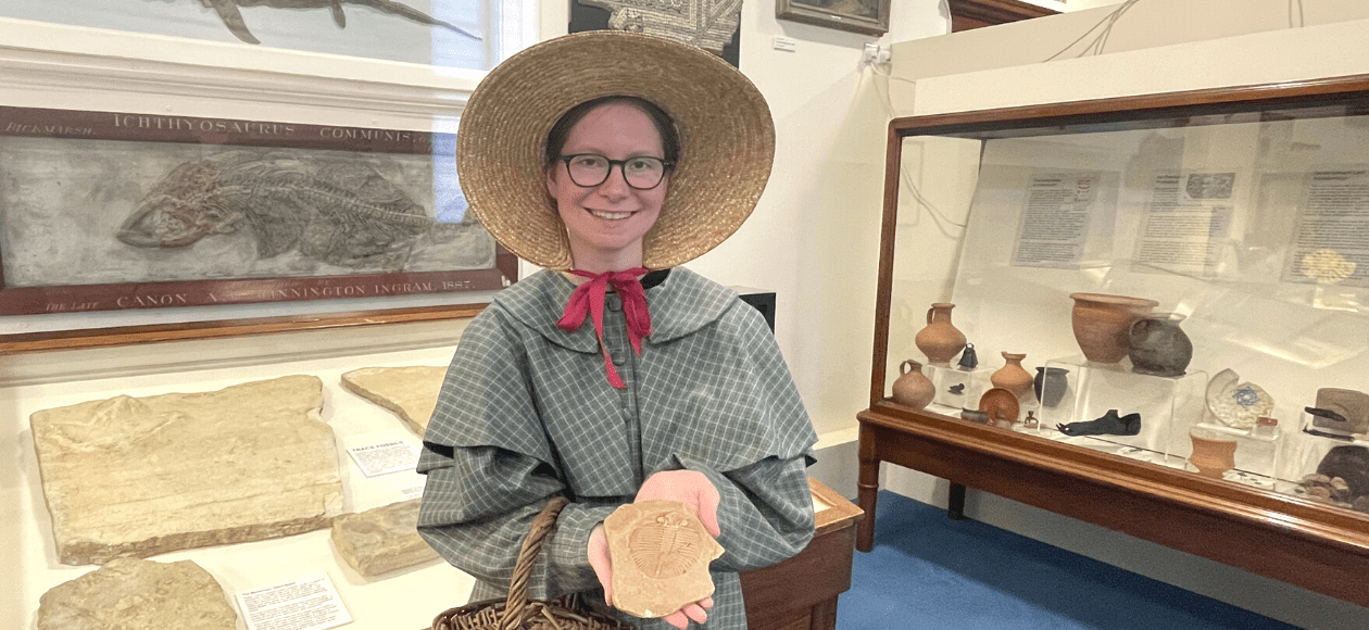 Mary Anning web header 2 A photo of Mary Anning holding a fossil in the museum at Worcester City Art Gallery and Museum.