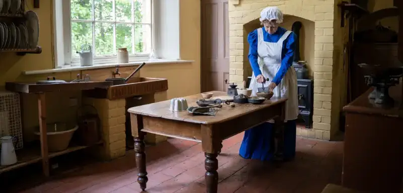 A woman dressed as a Victorian servant.