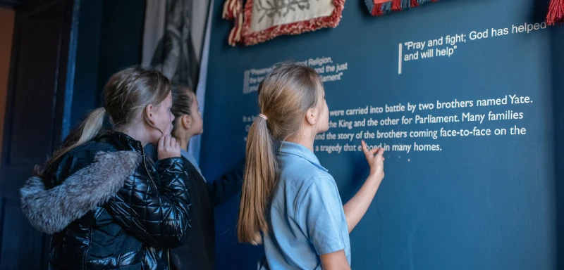 A photo showing school children looking around the museum.