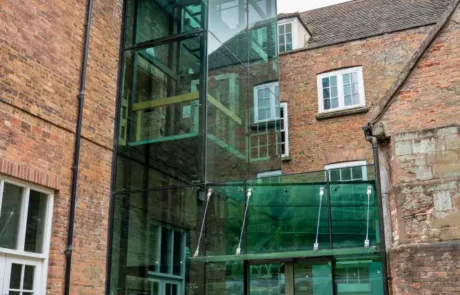 A photo showing the glass lift at Hartlebury Castle from the outside of the building.